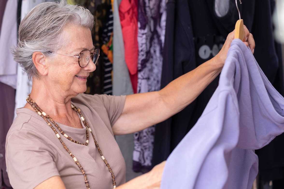 older adult going through closet