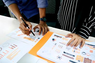 two people reviewing reports