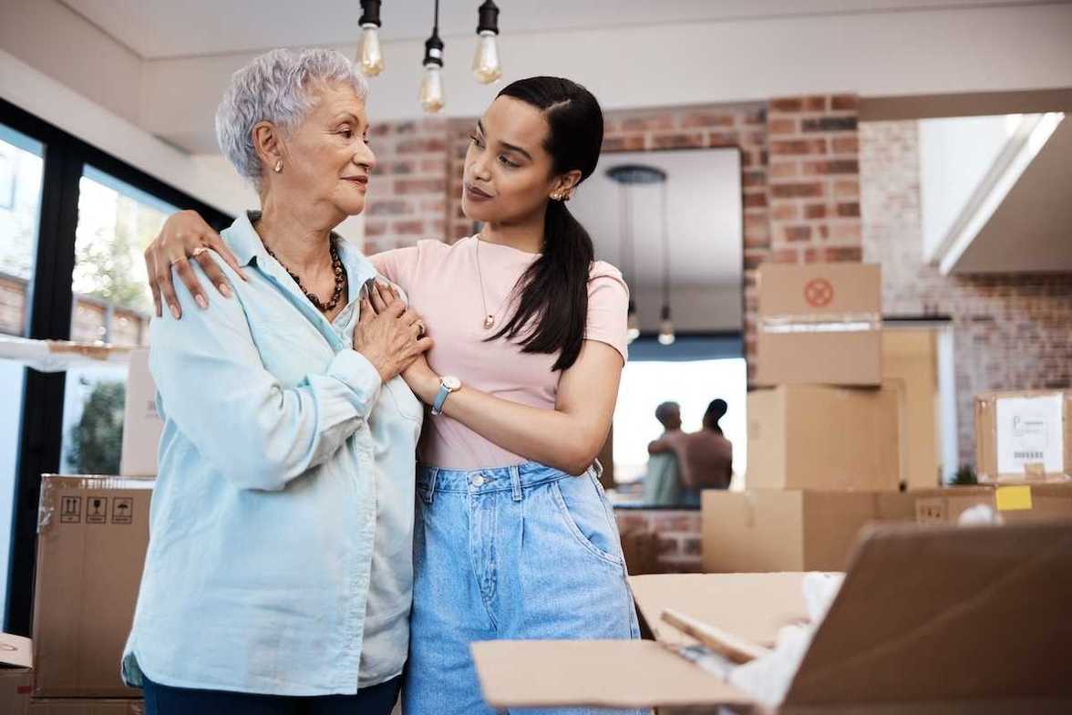 Senior taking help from their daughter to pack 